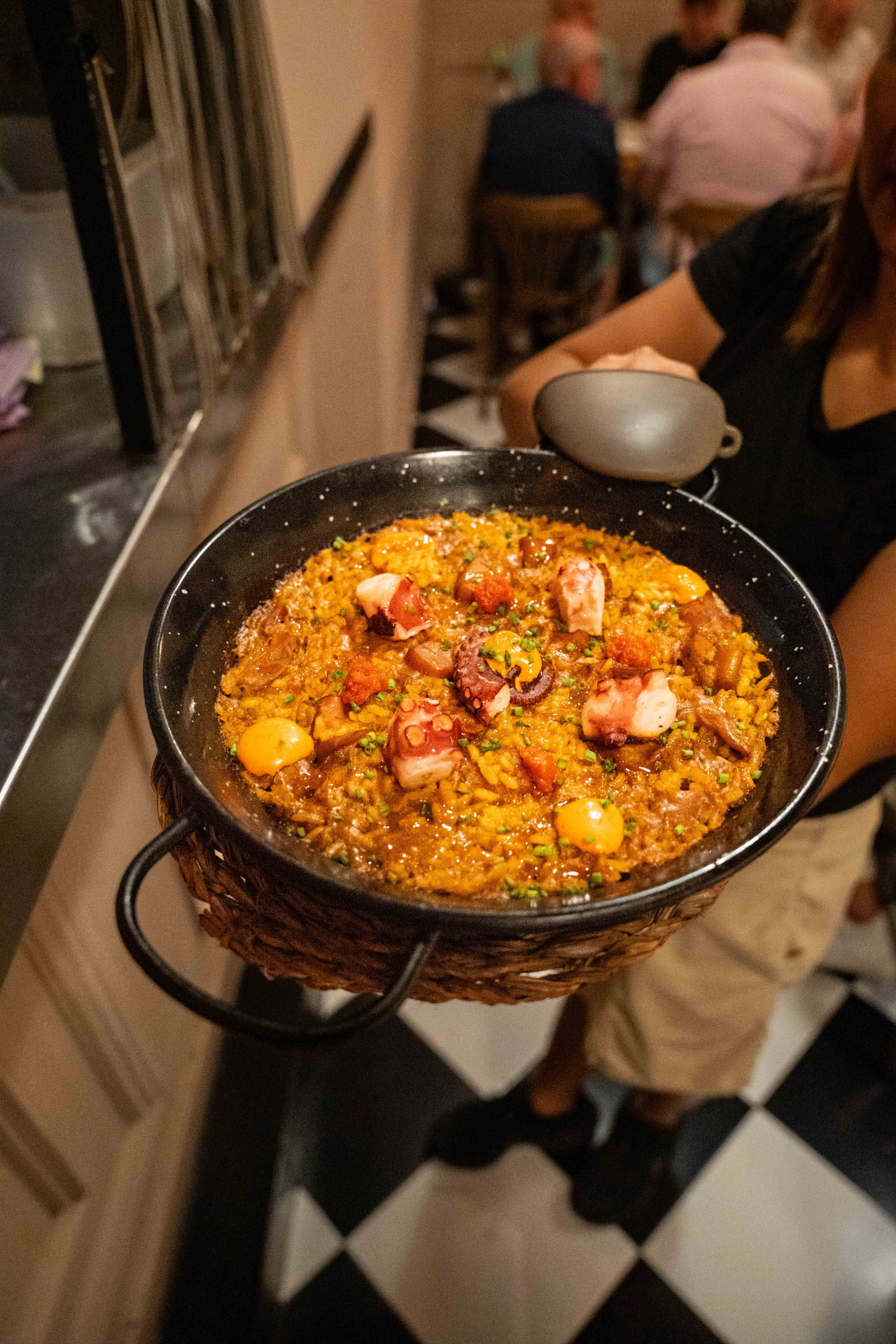 Rice with octopus and chorizo in a paella pan
