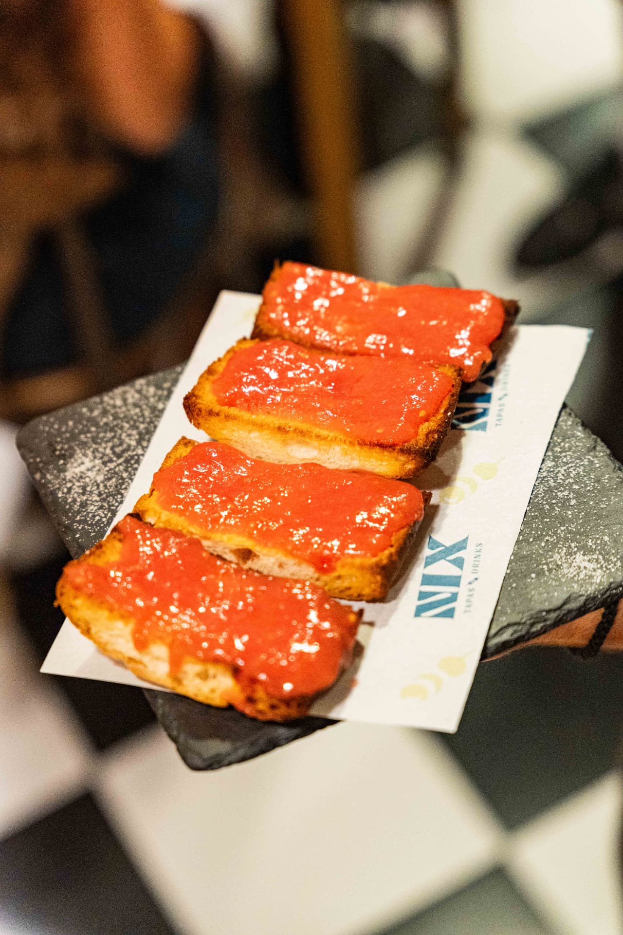 Pan con tomate on slate with the Nix Tapas & Drinks napkin